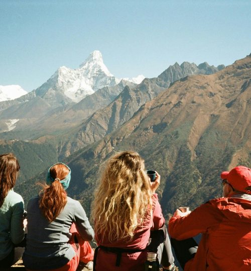 Group of hikers enjoying the stunning Himalayan view from Namche, Nepal.